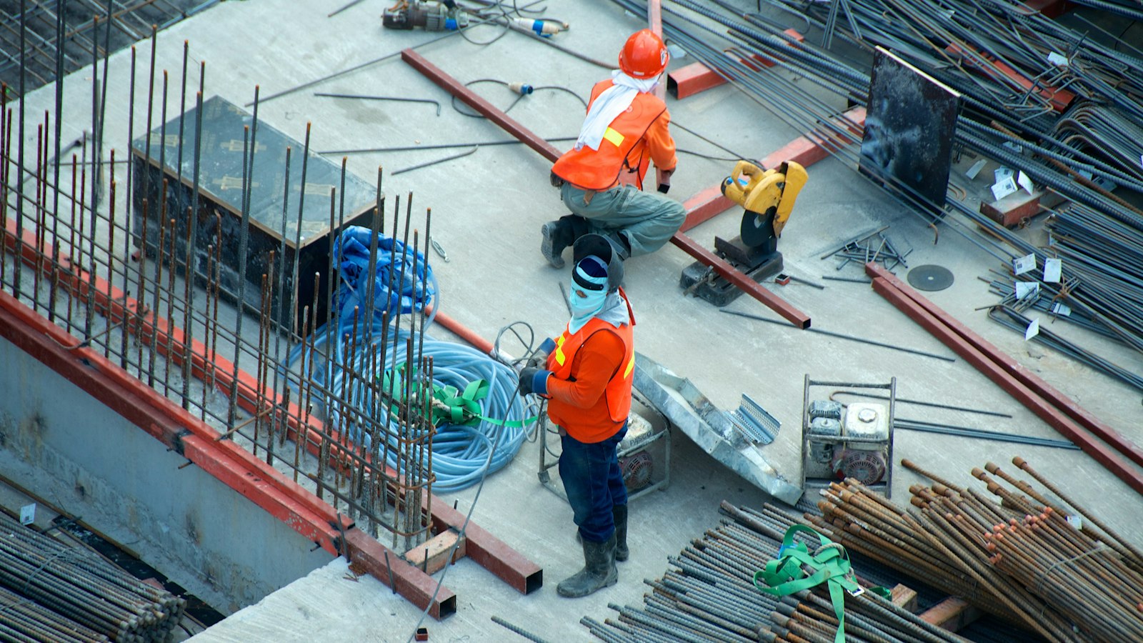 Construction crew working on an active jobsite with scaffolding and building structure