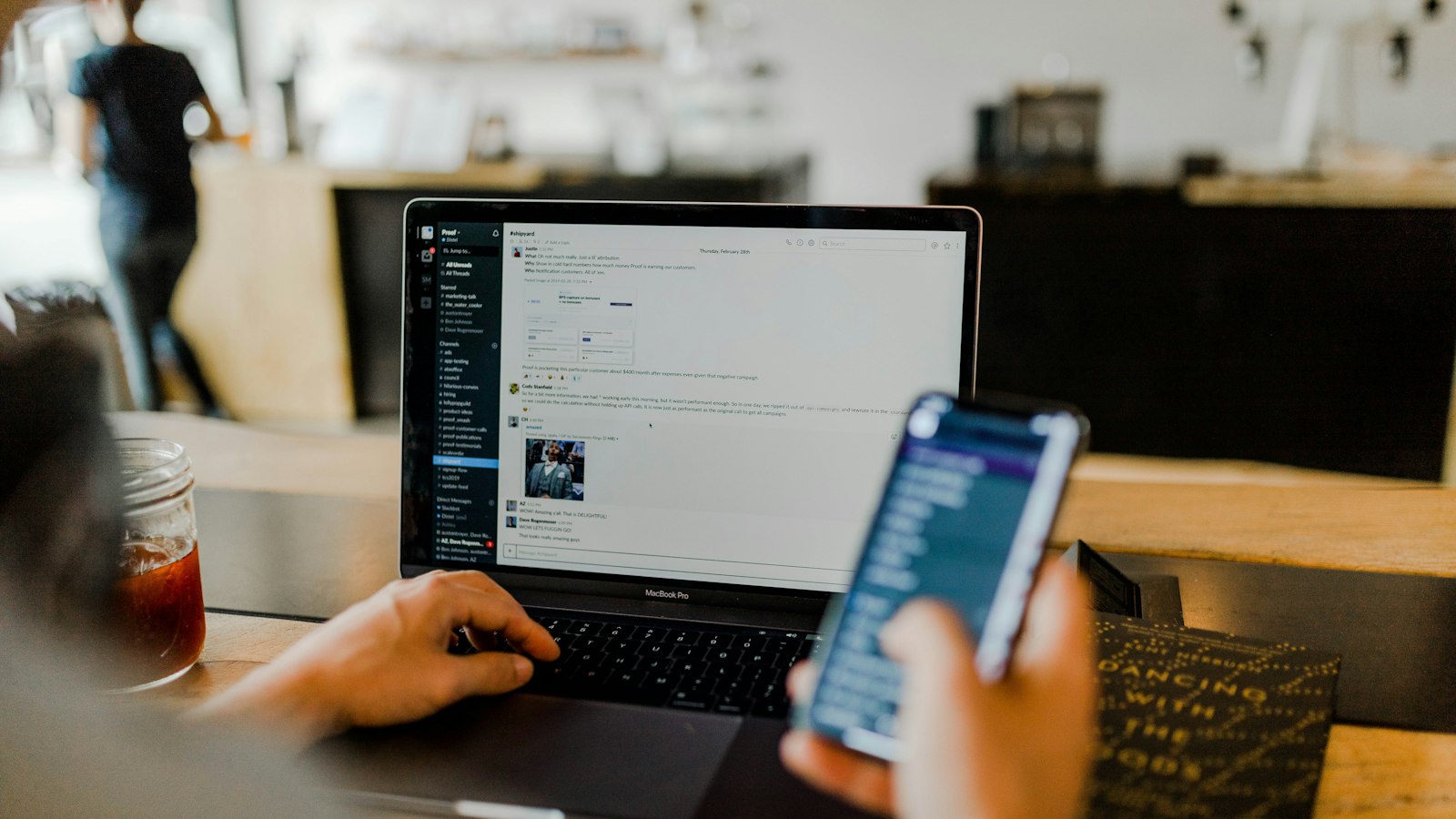 Hands working on a digital device with network security graphics overlay